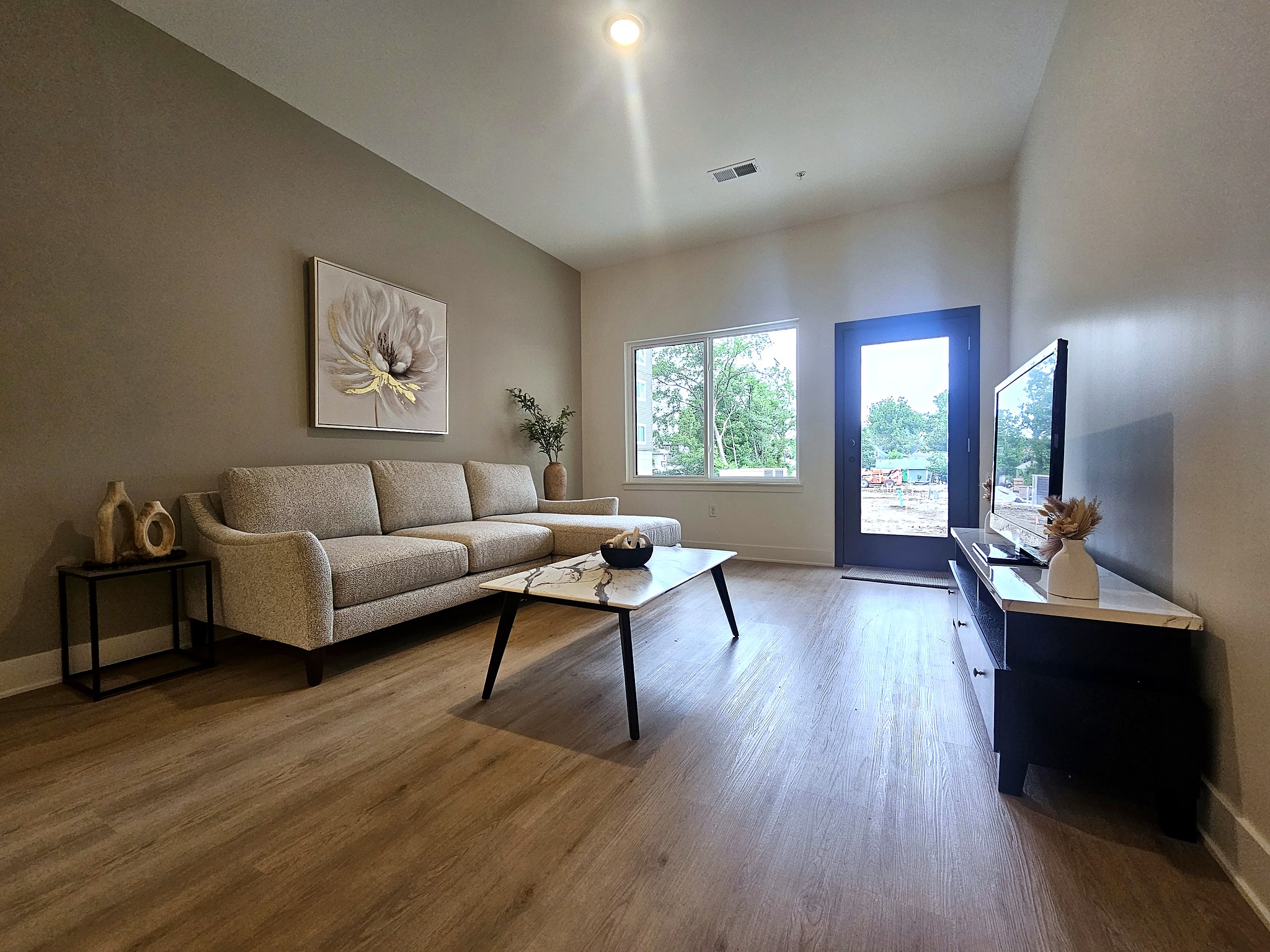 apartment living room with a sofa, coffee table, and minimal decor